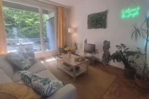 a living room with a couch and a table at Paradise Jungle in Paradiso