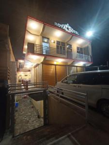 a building with a car parked in front of it at Royal hotel jaglot gilgit in Gilgit