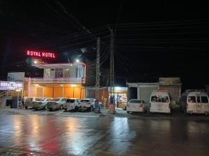 a parking lot with cars parked in front of a hotel at Royal hotel jaglot gilgit in Gilgit