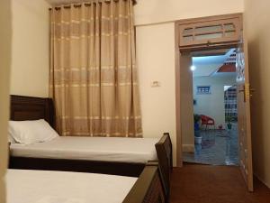 a bedroom with two beds and a door with a window at Royal hotel jaglot gilgit in Gilgit +7 photos