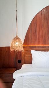 a bedroom with two beds and a chandelier at Heritage Stay in Bingin Beach