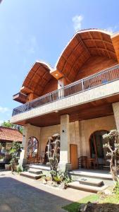 a large building with a balcony on top of it at Heritage Stay in Bingin Beach