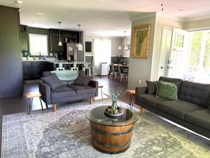 a living room with two couches and a table at Belvidere Mountain Vista Home by Stowe Jay Peak Smuggs Long Trail in Belvidere Center