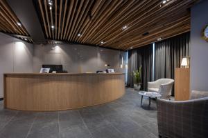 an office lobby with a reception desk and chairs at Hotel Restaurant Alte Brauerei in Celerina