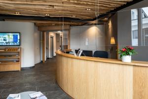 an office lobby with a reception desk and a counter at Hotel Restaurant Alte Brauerei in Celerina
