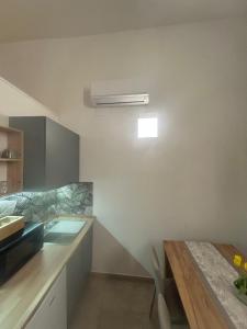 a kitchen with a sink and a table at Ciemme Apartments in Castellammare di Stabia