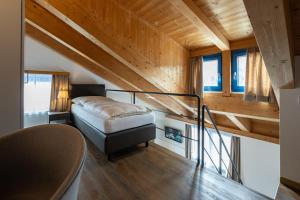 a small bedroom with a bed and a staircase at Hotel Restaurant Alte Brauerei in Celerina +32 photos