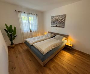 a bedroom with a bed and a plant in it at Ferienwohnung "Große Auszeit" in Schongau