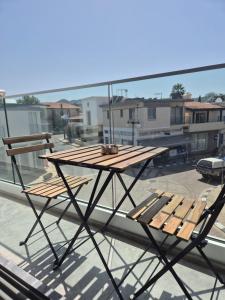a wooden table and two chairs on a roof at AK Appartment in Kato Pyrgos