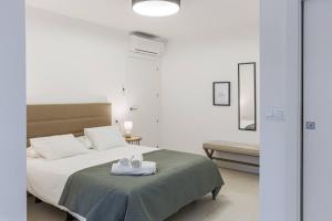 a bedroom with a bed with a tray on it at Royar Apartamentos in Jaén