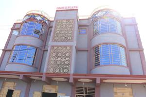 a building with blue windows on the side of it at KilimaVista Homes 1 bedroom apartment in Kimana