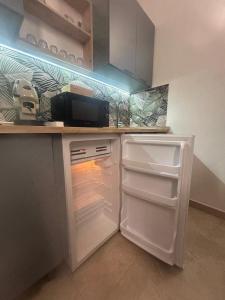 a kitchen with an oven with an open refrigerator at Ciemme Apartments in Castellammare di Stabia +18 photos