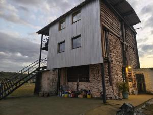 a large building with a staircase on the side of it at Alpes Goianos - Suítes in Cavalcante