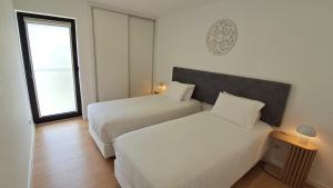a hotel room with two beds and a window at Furnas Springs in Furnas