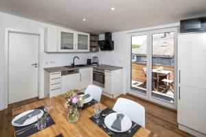 a kitchen and dining room with a table and chairs at Gästeappartements Mechels in Wilnsdorf