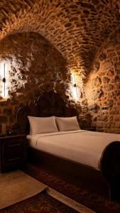 a bedroom with a large bed in a stone wall at Terrace Merdin Konagı in Mardin