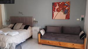 a living room with a bed and a couch at DINASTIE PALACE in Chajarí