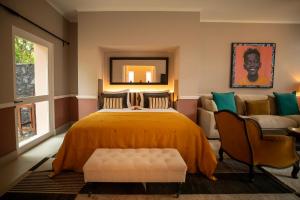 a bedroom with a bed and a couch at Belo Monte - Principe Collection in Santo António