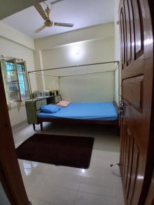 a bedroom with a bunk bed with a blue bed at Paras home in Deoghar +14 photos