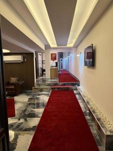 a red carpeted hallway with a long red carpet at Ydora Luxury Hotel in Bodrum City