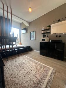 a living room with a couch and a rug at L7 Urban Studios in Tel Aviv