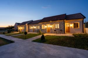 a house with a lot of lights on it at Avila Casa in Podgorica