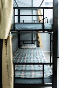 a bunk bed in a room with a pillow on a bunk bed at Lumi living hostel in Ho Chi Minh City