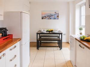 a kitchen with a small table with a bench in it at 3 Bedroom House By Trinity Stays Short Lets & Serviced Accommodation Cambridge With Free WiFi & Parking in Cambridge