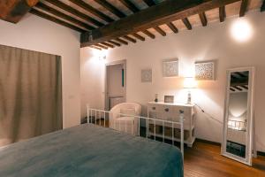 a bedroom with a bed and a table and a mirror at Relais L'Antico Convento in Galera +19 photos