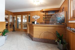 a bar in a restaurant with wooden walls at Albergo Caravasc in Livigno
