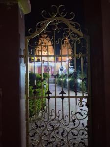 an iron gate with a view of a garden at Paras home in Deoghar