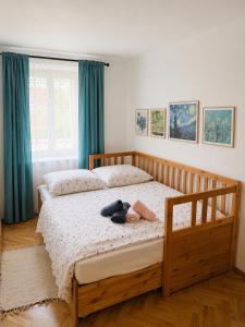 a bedroom with a bed with a teddy bear on it at Škorničkův statek - chalupa Andělka s wellness za příplatek in Hamr