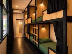 a room with four bunk beds in a building at Smith & Appy Backpackers Hostel in Nathon Bay