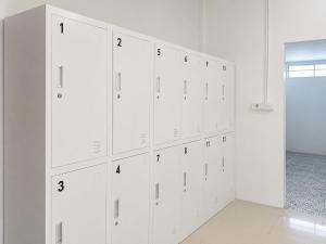 a row of white cabinets in a room at Smith & Appy Backpackers Hostel in Nathon Bay