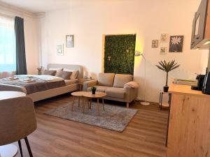 a living room with a bed and a couch at Apartments Chloe - Top 3 in Hollabrunn