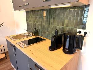 a kitchen with a sink and a coffee maker on a counter at Apartments Chloe - Top 3 in Hollabrunn