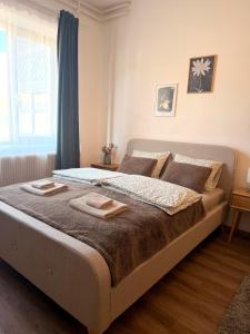 a bedroom with a bed with two towels on it at Apartments Chloe - Top 3 in Hollabrunn