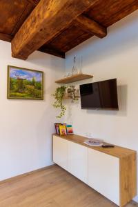a kitchen with white cabinets and a flat screen tv on the wall at Ferienhaus Sterzhansl in Pongratzen