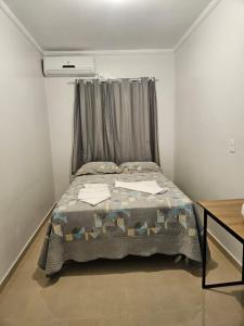 a bedroom with a bed with a curtain at Casa de Charles in Piranhas