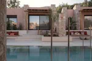 a house with a swimming pool next to a house at NINEMO Village in Fternón +48 photos