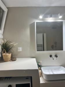 a bathroom with a sink and a mirror at Aelia in Vári +28 photos