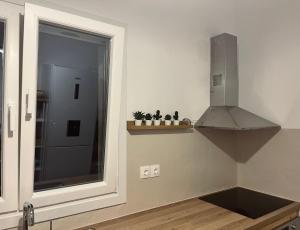 a kitchen with a window and a stove top oven at Aelia in Vári