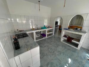 a kitchen with white cabinets and a counter top at Bliss home in Watamu