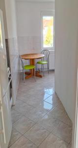 a room with a table and chairs and a table and a window at Dziwnów 2 in Dziwnów