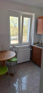 a kitchen with a table and chairs and a window at Dziwnów 2 in Dziwnów