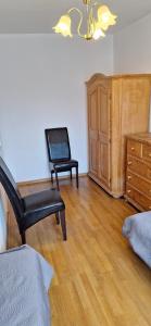 a living room with a chair and a dresser at Dziwnów 2 in Dziwnów