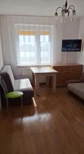 a living room with a table and a couch at Dziwnów 2 in Dziwnów