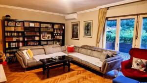 a living room with a couch and a table at Kiwi house in Podgorica