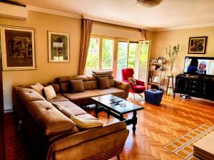 a living room with a couch and a coffee table at Kiwi house in Podgorica +6 photos