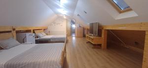 a bedroom with two beds and a tv in a room at Casa Marinela in Baile Felix +167 photos